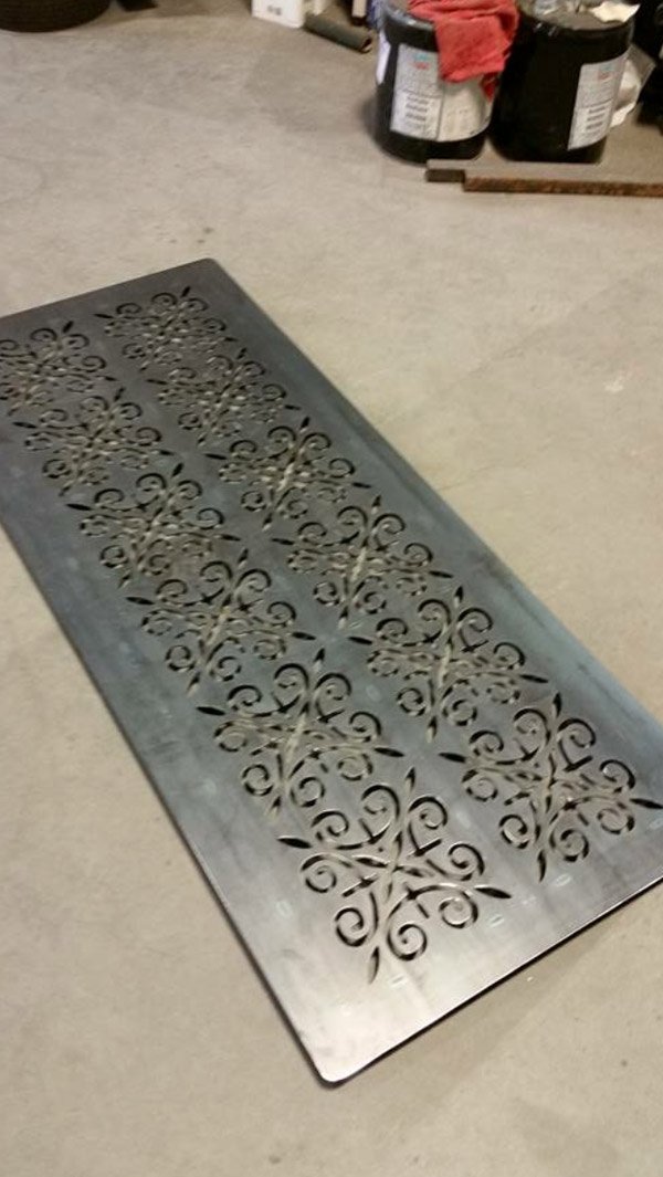 design being carved out on a metal plate