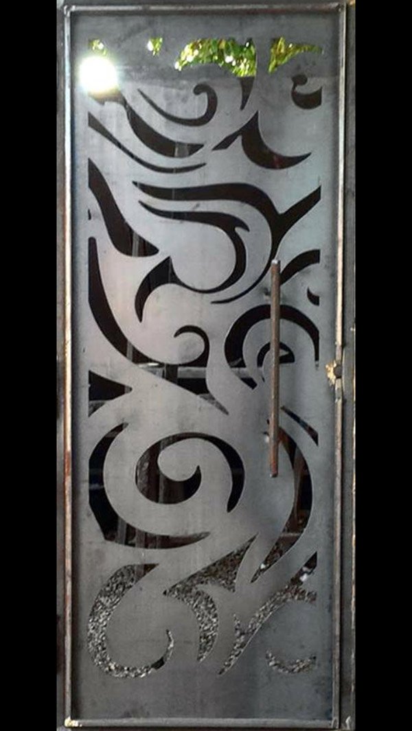 design being carved out on a metal plate